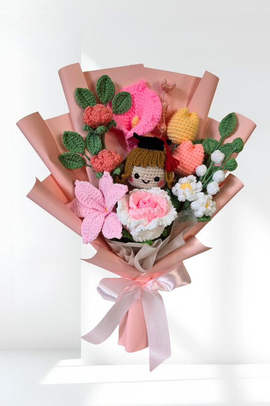 Bouquet of knitted flowers with a small doll in the center on a white background