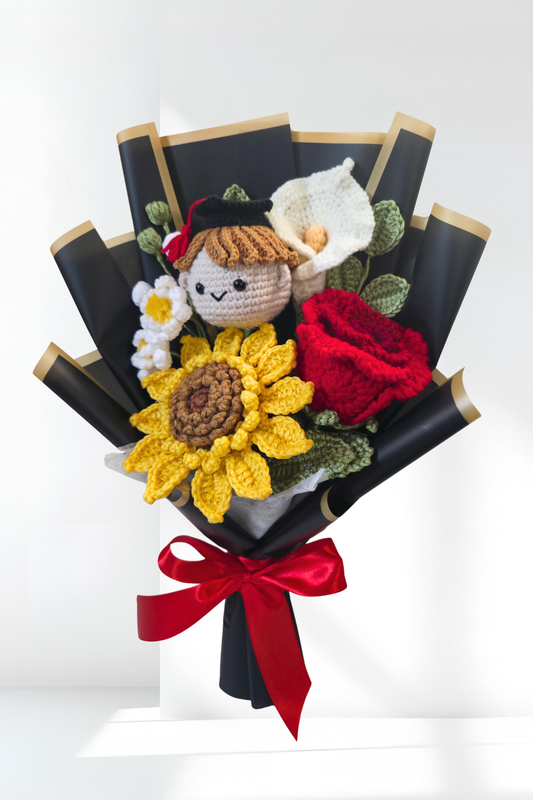 Graduation bouquet of crocheted flowers with a red ribbon on a white background