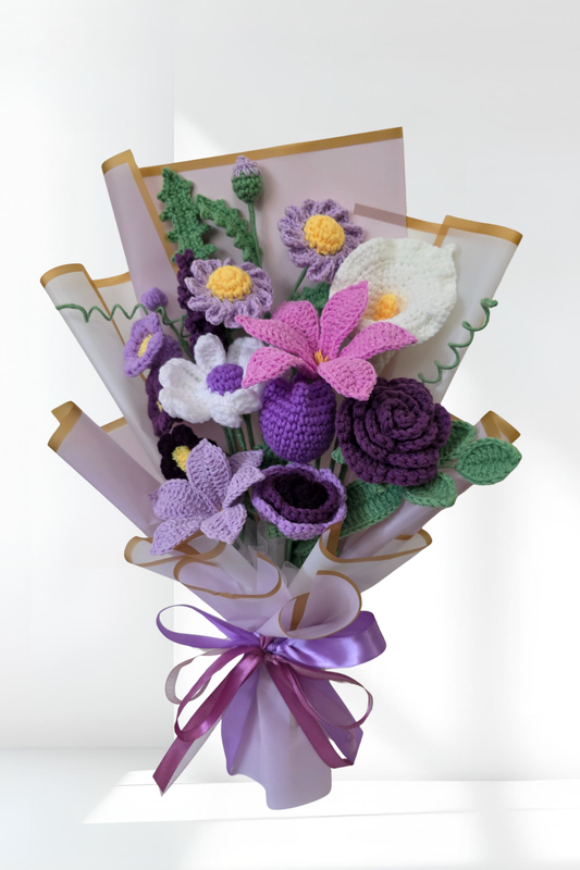 Crochet flower bouquet with a purple ribbon on a white background