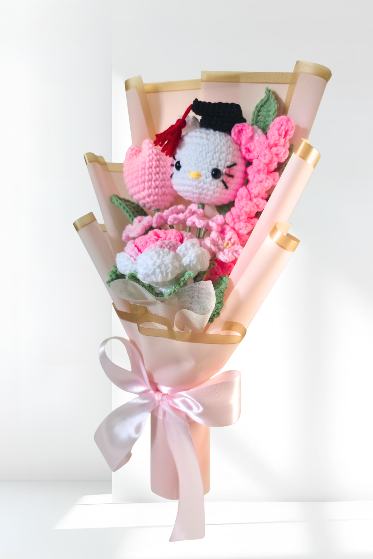 crochet graduation flower bouquet with a hello kitty figure