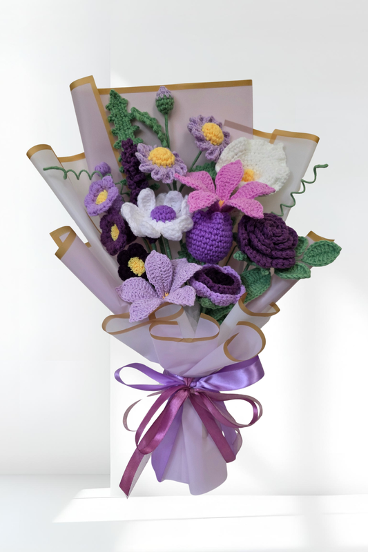 Bouquet of crochet flowers with a purple ribbon on a white background