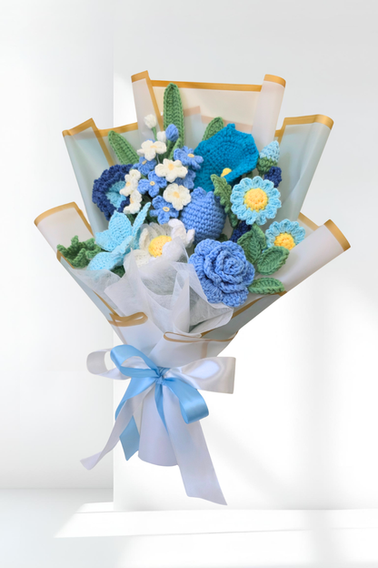 Bouquet of knitted flowers with blue and green colors on a white background