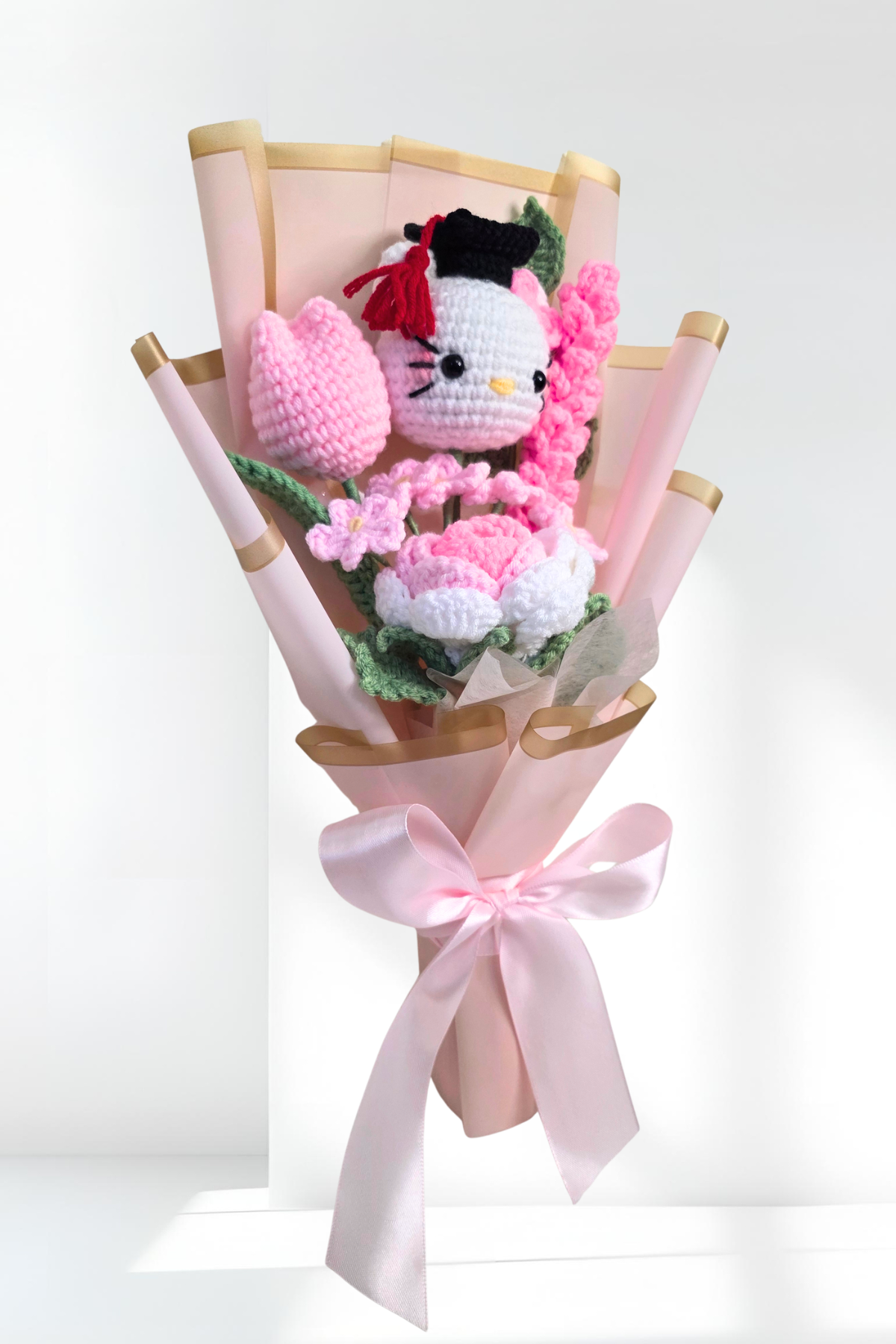 crochet graduation flower bouquet with a hello kitty figure
