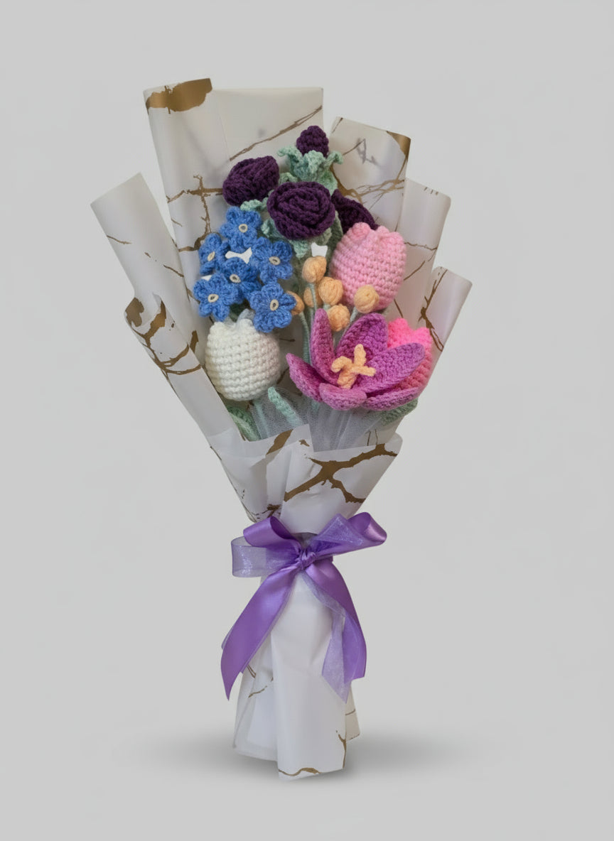 Bouquet of knitted flowers wrapped in paper with a purple ribbon on a light gray background
