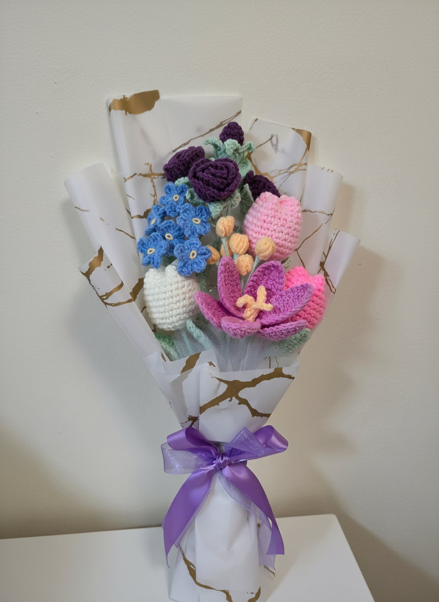 A crochet flower bouquet with charming blend of purple roses, blue blossoms, and soft pastel tulips