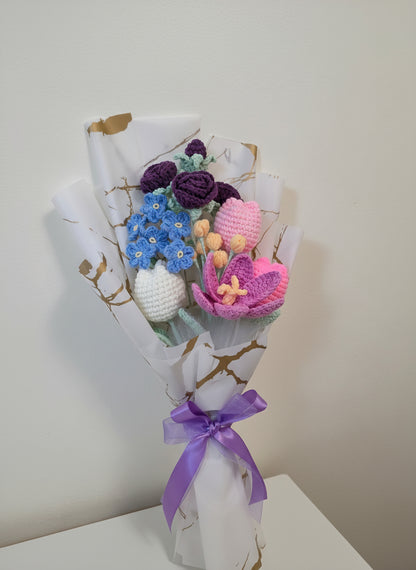 A crochet flower bouquet with charming blend of purple roses, blue blossoms, and soft pastel tulips