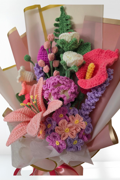 Crocheted flower bouquet in a pink paper wrap on a white background