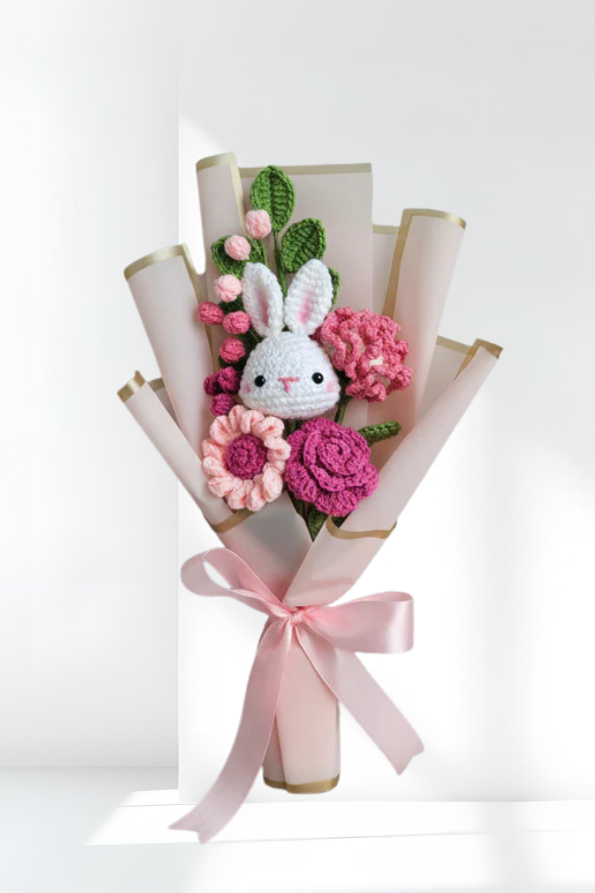 Bouquet with crochet bunny and flowers on a white background