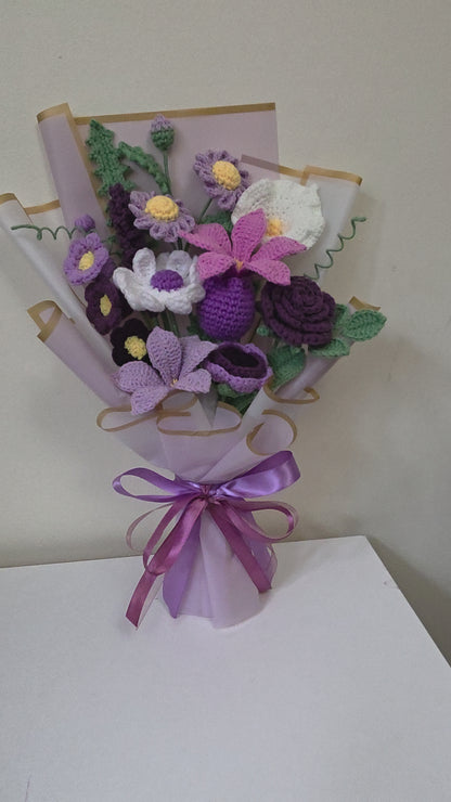 crochet flower bouquet with a purple ribbon on a white background