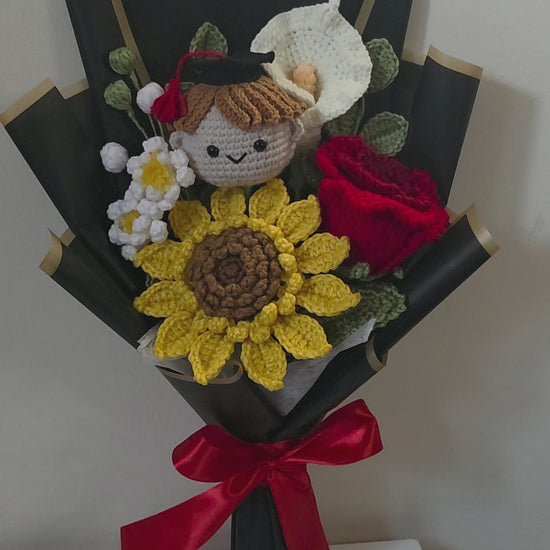 Graduation bouquet made of crochet flowers, and a small figurine on a white background