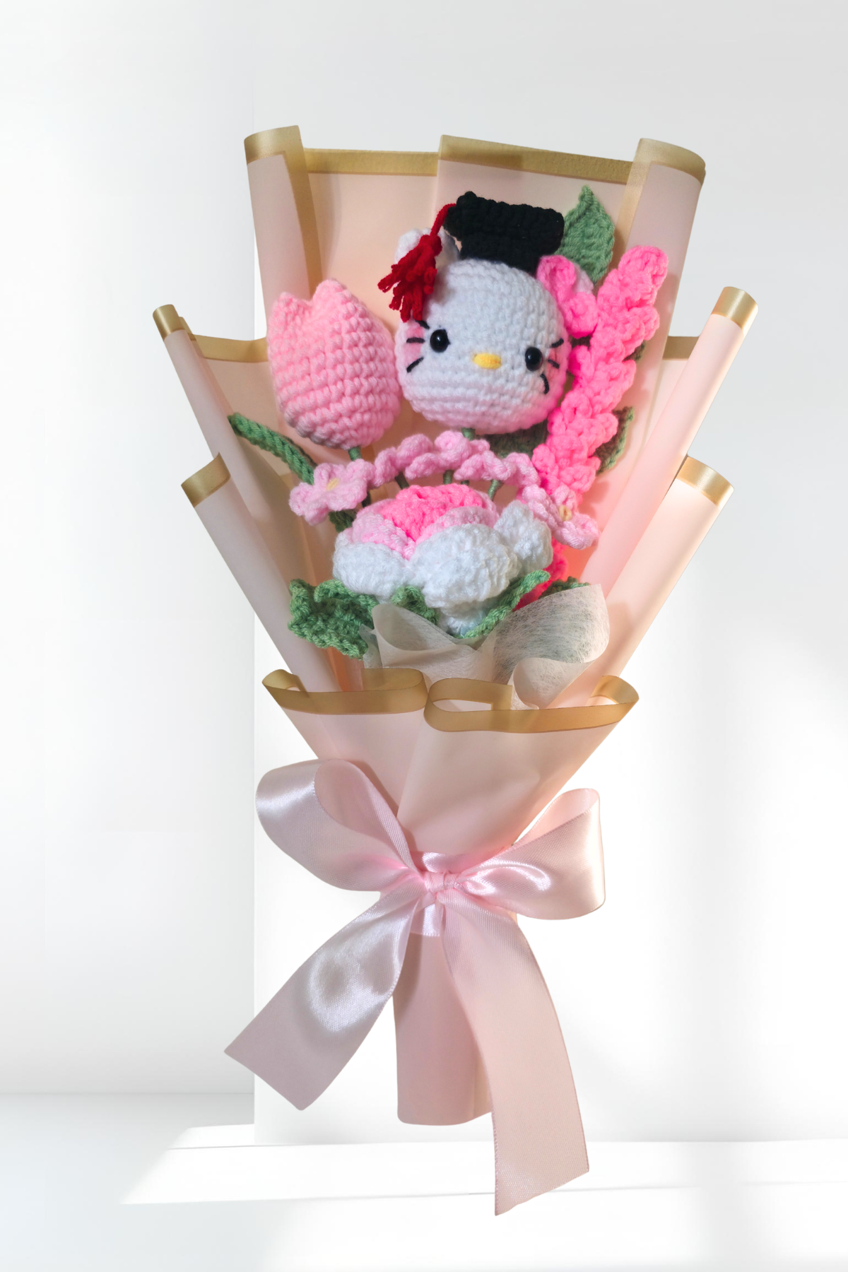 crochet graduation flower bouquet with a hello kitty figure