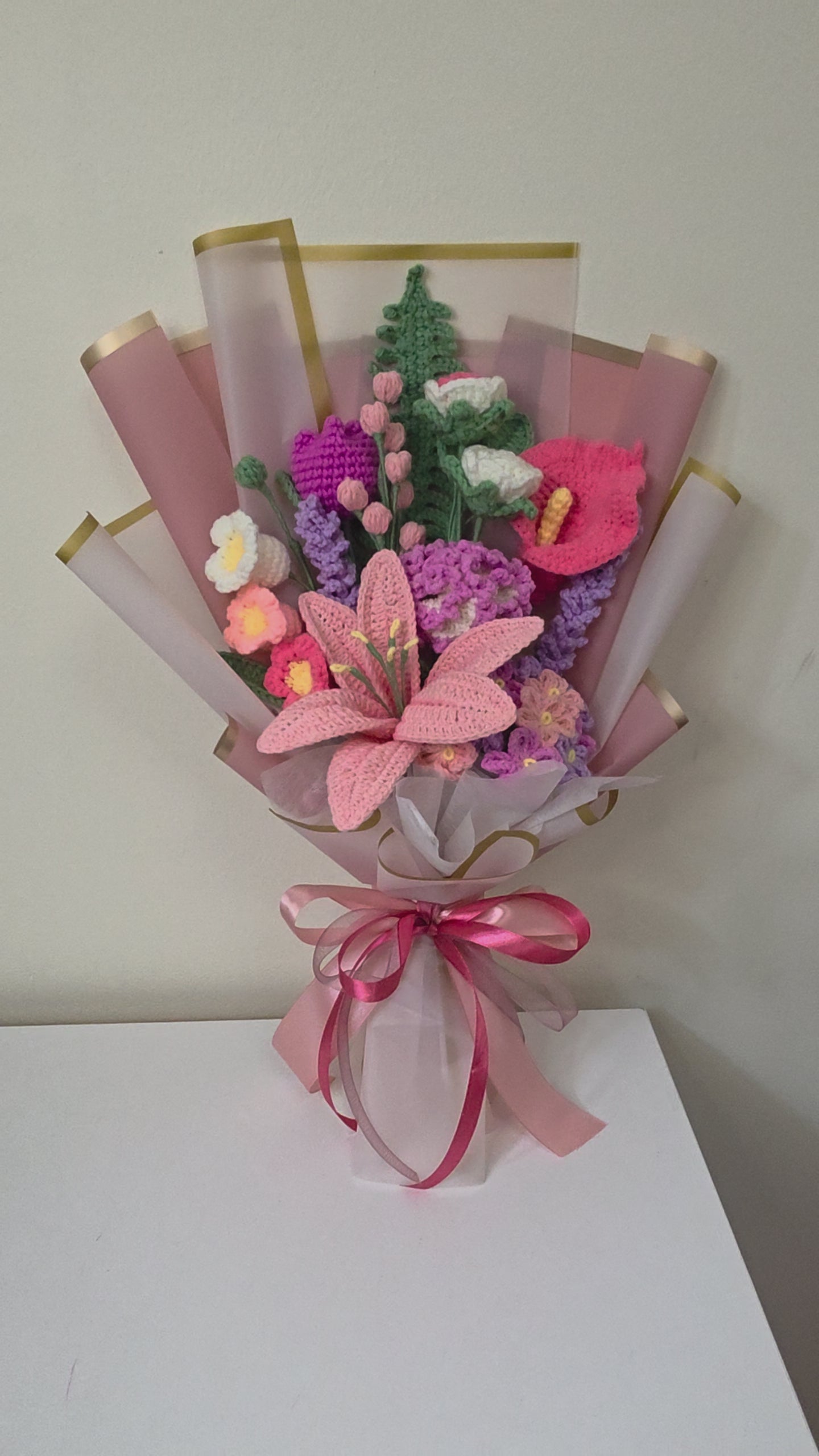 handcrafted crochet flower bouquet features a beautiful mix of lilies, blossoms, and delicate floral accents in soft pastel tones